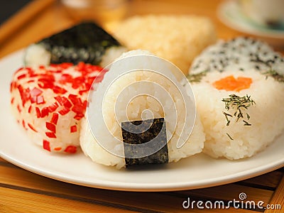 Onigiri of various shapes and fillings on a plate. Close-up food photo. Japanese rice ball Stock Photo