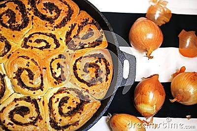 Onion bread rolls in ironcast pan, fresh golden onion Stock Photo