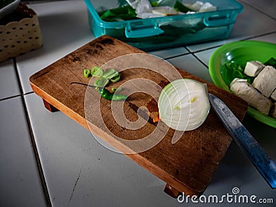 Onion sliced in half with a metal knife on the side Stock Photo