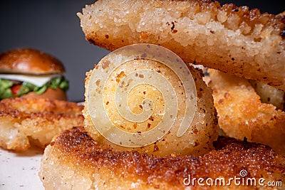Onion rings and potato balls, super mario. Burgers in the background Stock Photo