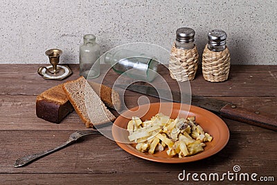 Onion, roasted potato, knive, salt, pepper and other things on t Stock Photo