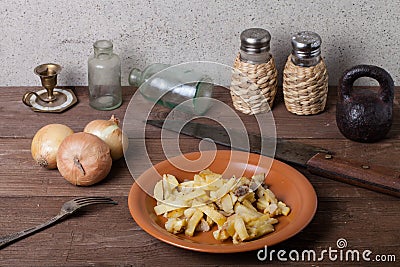 Onion, roasted potato, knive, salt, pepper and other things on t Stock Photo