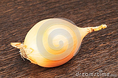 Onion on wooden surface Stock Photo