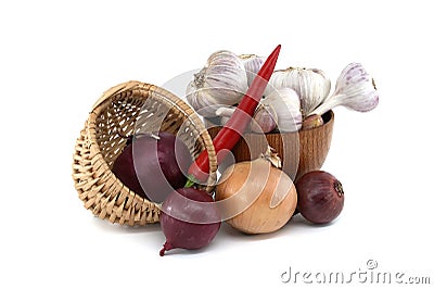 Onions in basket, garlic in bowl and red chili pepper Stock Photo