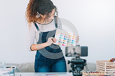 Online art course lady camera paint color swatch Stock Photo