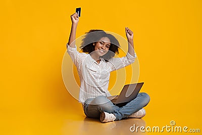 Happy Black Woman Celebrating Success With Laptop And Credit Card Stock Photo