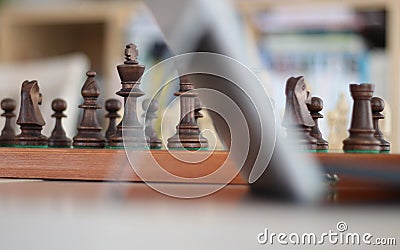 Online chess. Wooden pieces on a chessboards. Play Chess Online for all levels. From the cancellation of over the board chess by l Stock Photo