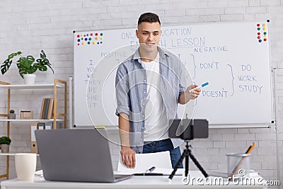 Online classroom remotely. Friendly teacher looks at camera and answers for students questions Stock Photo