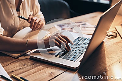 Always online. Close up of young woman working using computer while sitting in her workshop Stock Photo