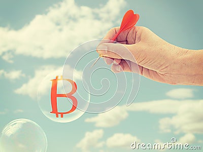 Bitcoin bubble about to burst,hand with dart. Risk. Stock Photo