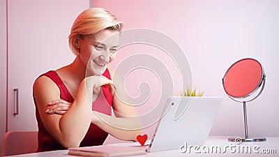 Online dating. Young woman in red dress having online date on Valentines day Stock Photo