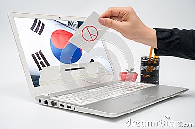 Online election concept. The hands of a male voter who casts a ballot on a laptop monitor Stock Photo
