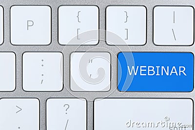 Online learning. Blue button with word Webinar on computer keyboard, top view Stock Photo