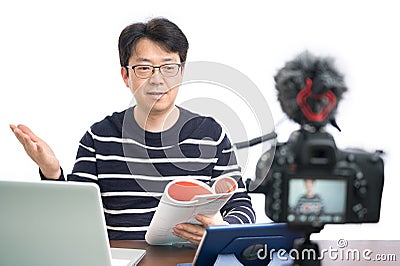 Online learning concept. An Asian middle-aged male teacher preparing to learn online Stock Photo