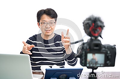 Online learning concept. An Asian middle-aged male teacher preparing to learn online Stock Photo