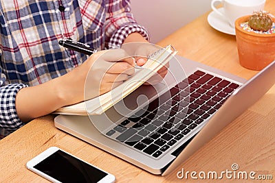 Online learning course concept. student using computer laptop for training online course and writing lecture note in notebook. Stock Photo