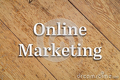 `Online Marketing` text on a wooden background. Stock Photo