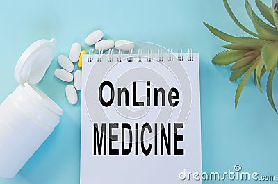 Online medicine-text inscription on a paper Notepad. News information, consultation, remote appointment with a specialist doctor Stock Photo