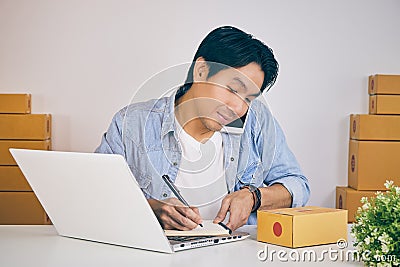 Online Merchant Talk with Customer Via Smartphone and Write Notebook in Vintage Tone Stock Photo