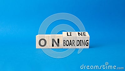 Online Onboarding symbol. Turned wooden cubes with words Online Onboarding. Beautiful blue background. Business and Online Stock Photo