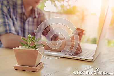 Online payment, Man`s hands holding a credit card and using smar Stock Photo