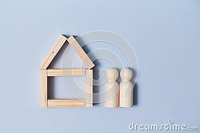 Online property sale. Booking house. Rent accommodation. Remote reservation. Wooden home, persons figures, copy space Stock Photo