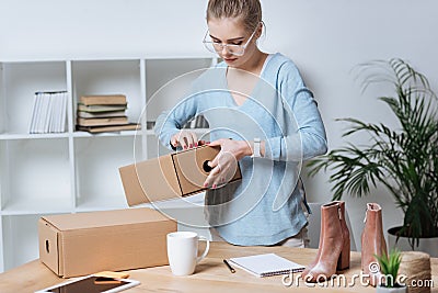 online shop proprietor with cardboard boxes working Stock Photo