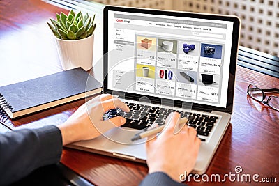 Online shop website developer working with a laptop, office desk background Stock Photo