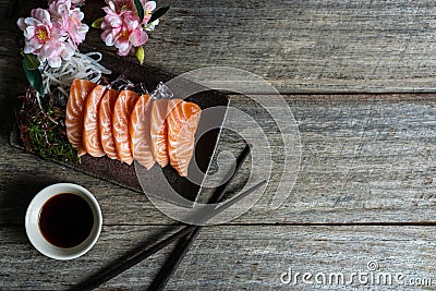 Close up of fresh salmon sashimi, wasabi on wooden background , Copy space, top view Stock Photo