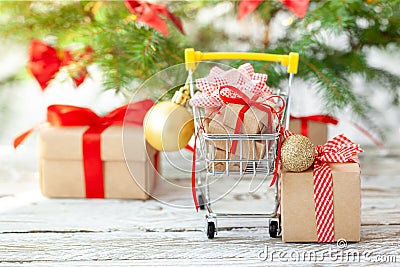 Online shopping concept - full Shopping Cart and gift boxes. Trolley full of different Christmas gift boxes with red ribbon on Stock Photo