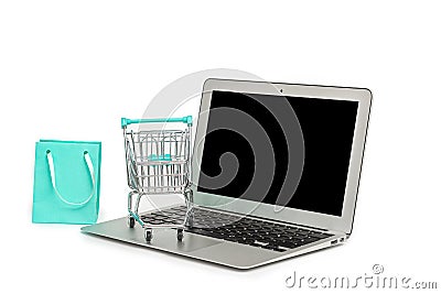 Online shopping concept with laptop computer, shopping bag and cart isolated on white, copy space Editorial Stock Photo