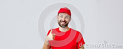 Online shopping, delivery during quarantine and takeaway concept. Smiling handsome bearded delivery guy or courier in Stock Photo