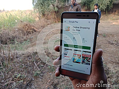 online shopping for kid app displayed on smart phone screen at agriculture field in india dec 2019 Editorial Stock Photo