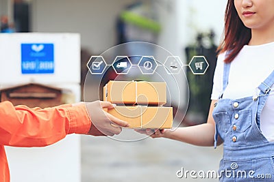 Online shopping, Woman receiving parcel from delivery man bringing some package at the home, shipping and postal service concept Stock Photo