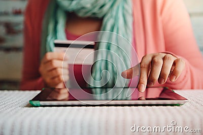 Online shopping - young woman with credit card in hand paying or booking in internet shop Stock Photo