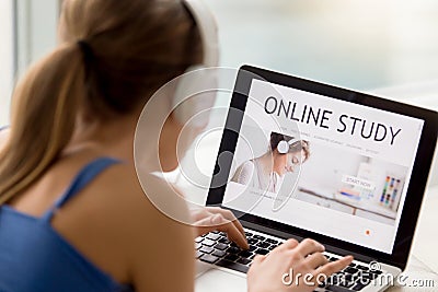 Online study concept, young woman wearing headphones searching a Stock Photo