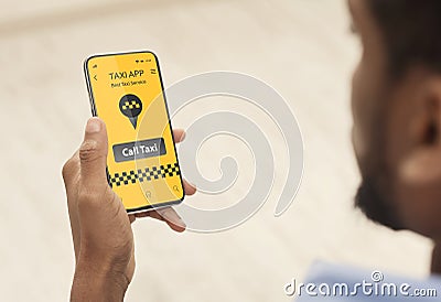 Online taxi service application. Closeup of black guy booking car via mobile phone app, waiting for cab transfer at home Stock Photo