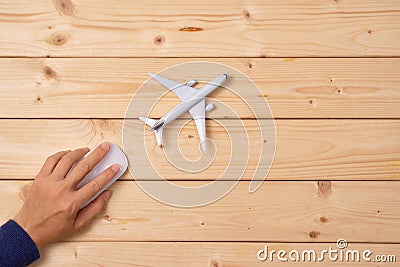 Online travel booking concept. Airplane model and computer mouse Stock Photo