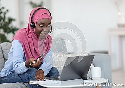 Online Tutoring. Friendly black muslim female tutor having video call with students Stock Photo