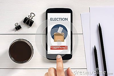 Online voting concept on smart phone screen with office objects Stock Photo