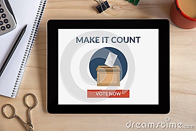 Online voting concept on tablet screen with office objects on wooden desk Stock Photo