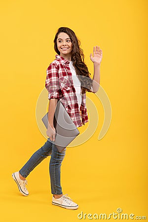 Online way of getting education. Happy child wave hand carrying laptop. Online courses Stock Photo