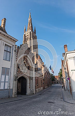 Onze Lieve Vrouw cathedral behind Gruuthuse entrance, Bruges, Belgium Stock Photo