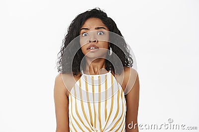 Oops smell problems. Portrait of stunned anxious good-looking african american woman with curly hairstyle being in Stock Photo