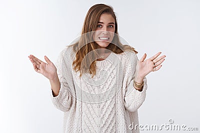 Oops sorry my fault. Portrait awkward guilty cute silly woman making mistake apologizing stooping clenching teeth Stock Photo