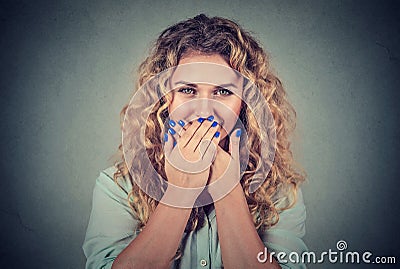 Oops! Surprised woman covering mouth with hands staring at camera Stock Photo