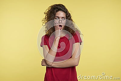 OOps, what is that Beautiful young woman keeps mouth rounded and looks a side, notices something unpleasant, poses Stock Photo