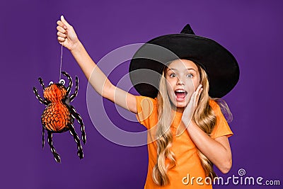 Oops. What have I done. Photo of small witch lady hold big hanging spider made it alive by accident wear wizard cap Stock Photo