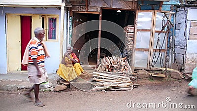 OOTY, INDIA - MARCH 2013: Local woman hanging laundry. OOTY, TAMIL NADU, INDIA - MARCH 2013: Everyday scene with local woman hanging laundry on cloth line stock footage OOTY, INDIA - MARCH 2013: Local woman hanging laundry. OOTY, TAMIL NADU, INDIA - MARCH 2013: Everyday scene with local woman hanging laundry on cloth line stock footage