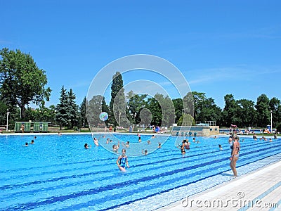 Open-air swimming pool with thermal water, people swim and play in the water Editorial Stock Photo